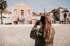 A Street Photographer Or A Young Woman Takes Pictures Of Authentic Houses In Lisbon In Portugal. A Professional Stock Images