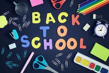 On A Black Background, School And Office Supplies Are Chaotically Arranged. In The Center Is The Inscription BACK TO Stock Photography