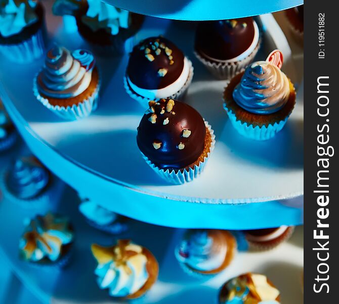 Selection of decorative desserts on buffet table at catered event