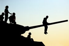 Silhouettes Of Children Climbing The Tank Stock Photography