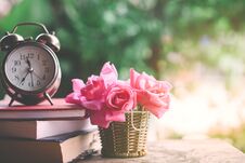 Pink Roses Bouquet ,clock And Book On Wooden Table Stock Image