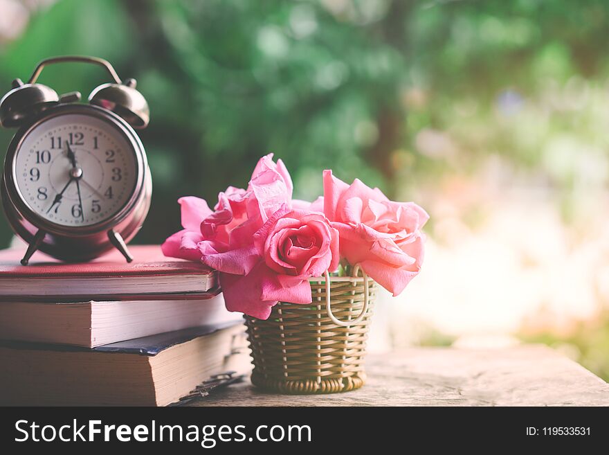 Pink Roses Bouquet ,clock And Book On Wooden Table