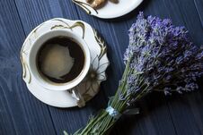 A Cup Of Coffee And Bouquet Of Lavender On A Dark Blue Wooden Table. Royalty Free Stock Photo