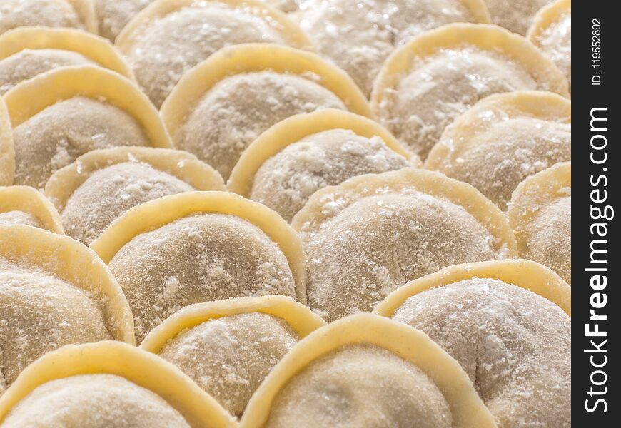 Traditional Russian handmade dumplings frozen on the board. Russian pelmeni. Ravioli