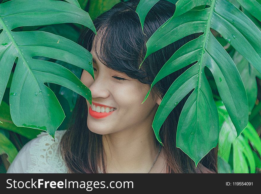 Close-Up Photography Of Girl Near Leaves