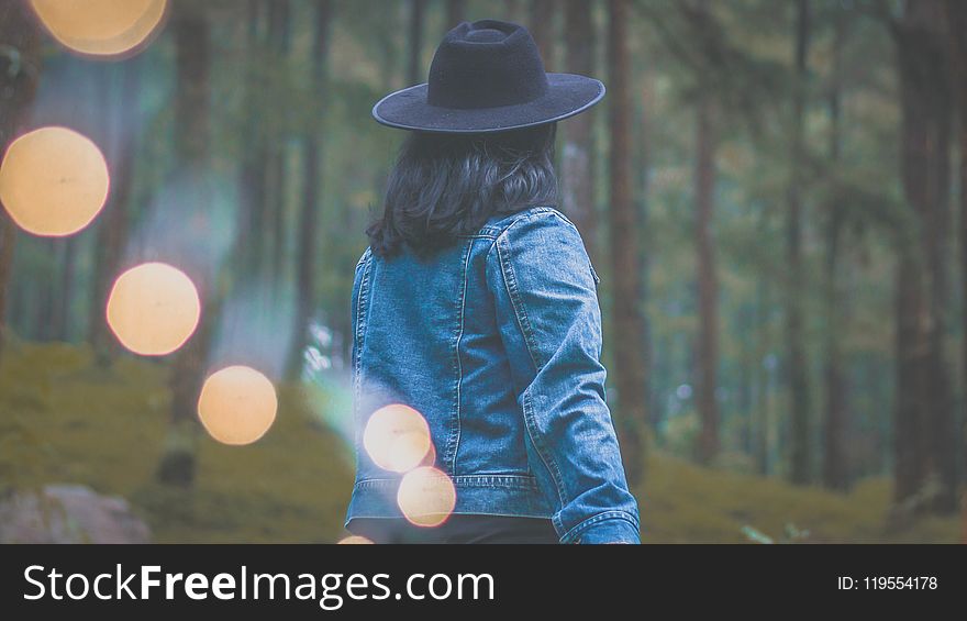 Photo of Woman Wearing Denim Jacket and Black Hat