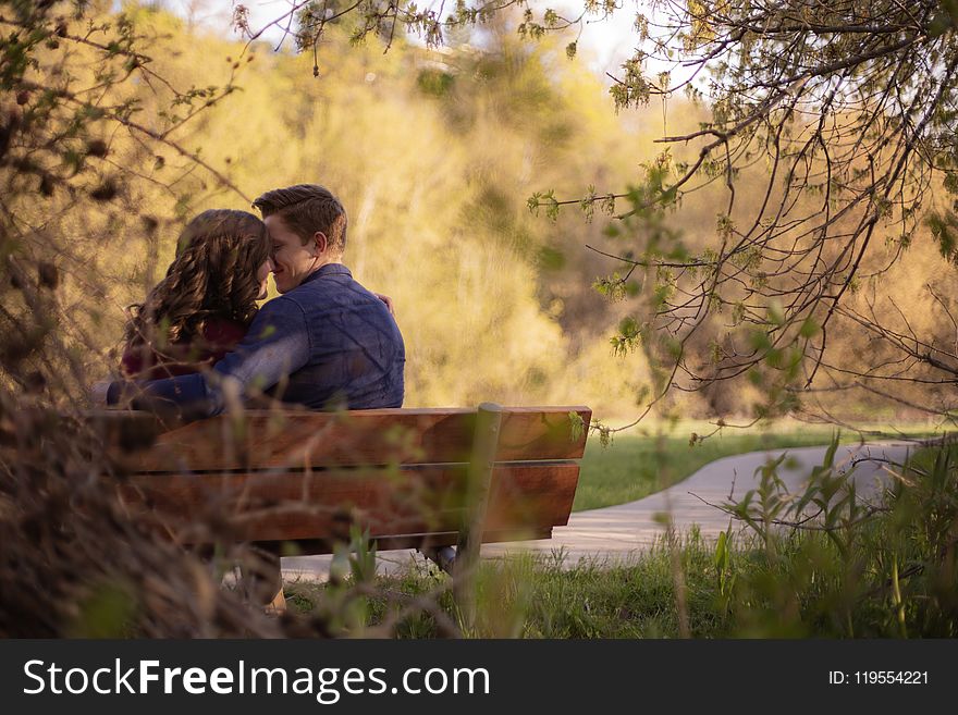 Photography Of Couple Sitting On Bench