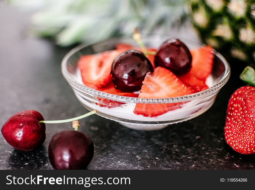 Cherries and Sliced Strawberries on Clear Bowl