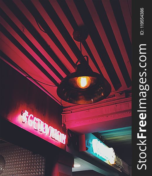 Round Brown Pendant Lamp on Red Ceiling Turned on