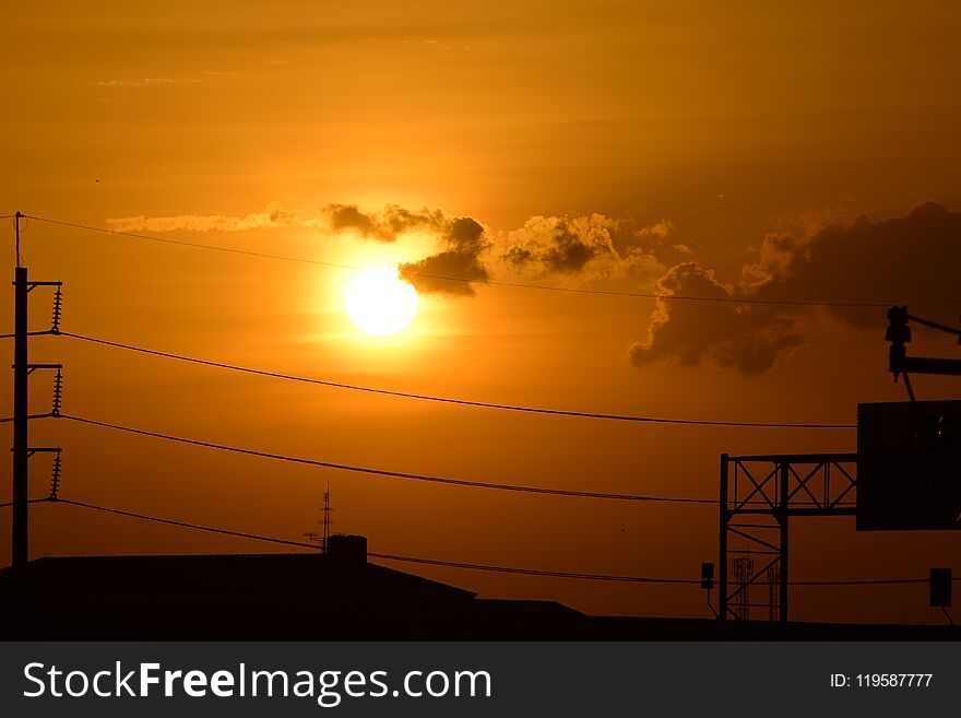 Golden sunset with poles and power lines.Power transmission system With the sky and the beautiful clouds in bright days. Golden sunset with poles and power lines.Power transmission system With the sky and the beautiful clouds in bright days.
