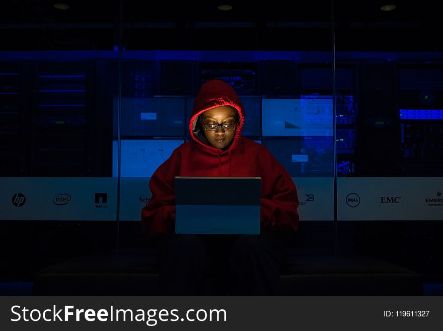 Woman Wearing Hooded Pullover Hoodie Facing Tablet Computer