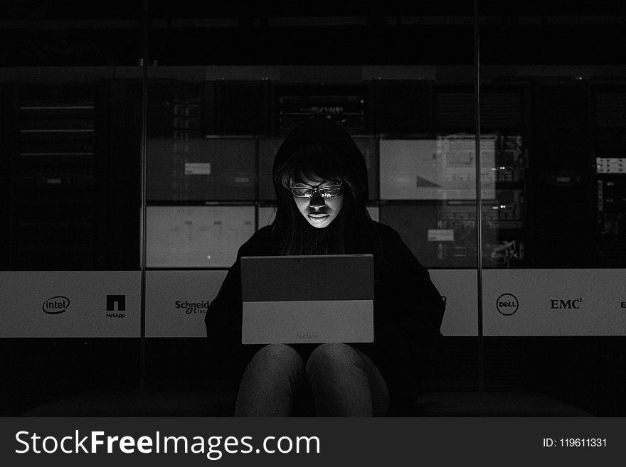 Gray scale Photograph of a Woman using a Laptop