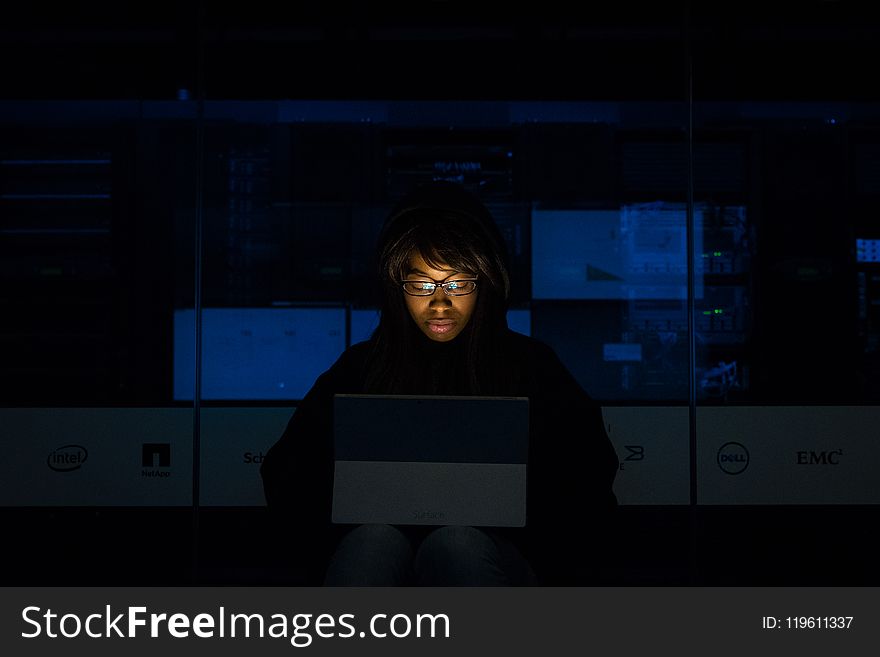 Woman Wearing Black Hoodie Jacket Holding Grey Laptop Computer