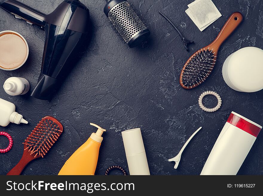 Image of hairdresser accessories, hair dryer, combs, in circle on empty black background