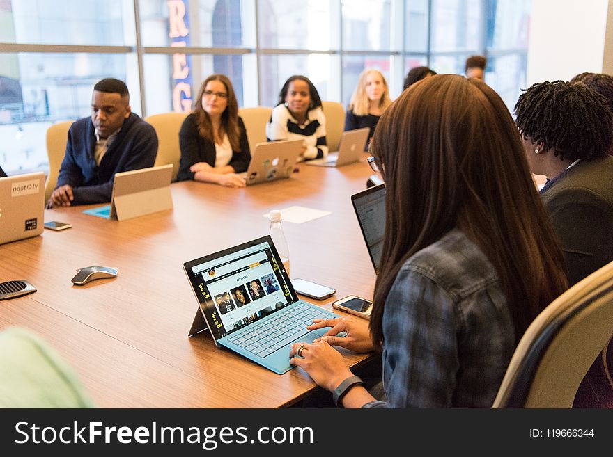 Group Of People Sitting Near Table