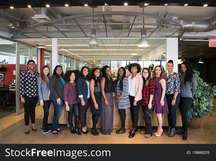Group of Women Standing Near Desk