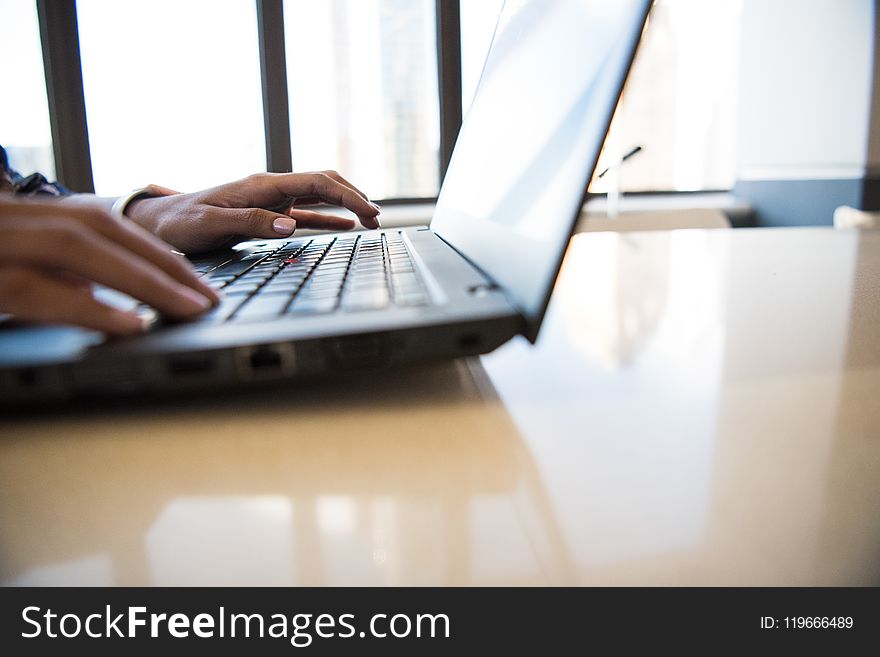 Black Laptop Computer on Brown Wooden Table