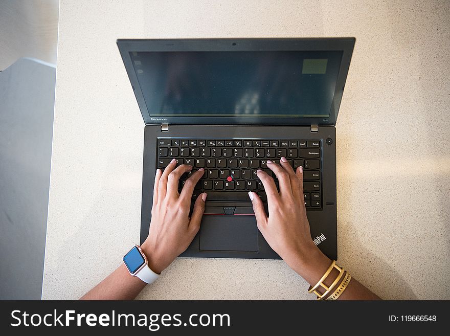 Human Hand on Black Lenovo Thinkpad