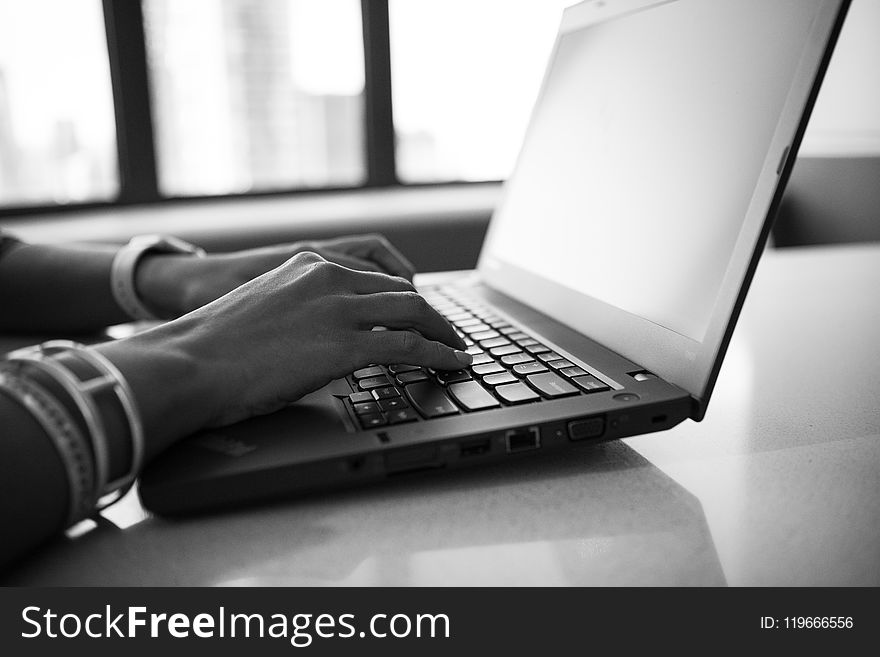 Grayscale Photography of a Woman Working in Front of Laptop