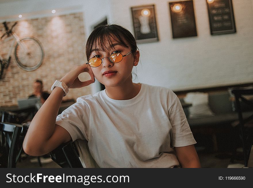 Woman Sitting Wearing Sunglasses