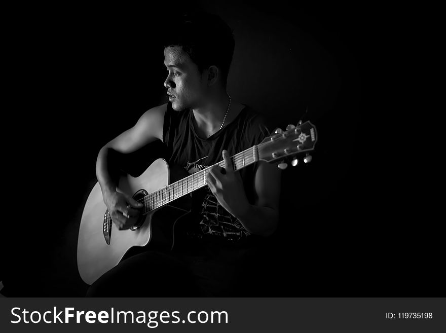 Monochrome Photography of Man Playing Guitar