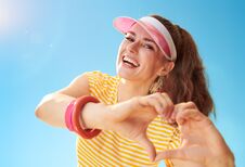 Happy Young Woman Against Blue Sky Showing Heart Shaped Hands Royalty Free Stock Photography