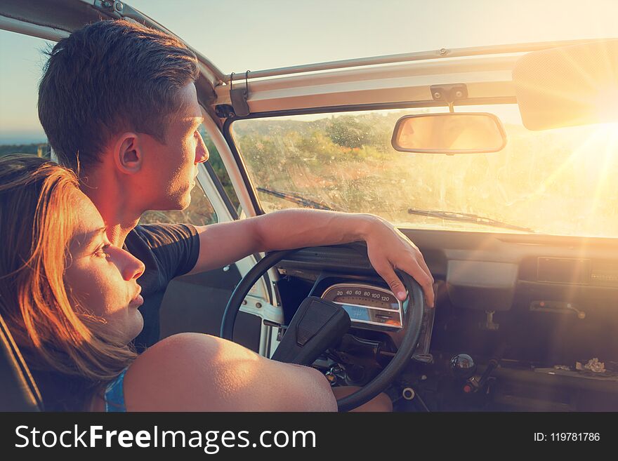 Couple In A Car At Sunset