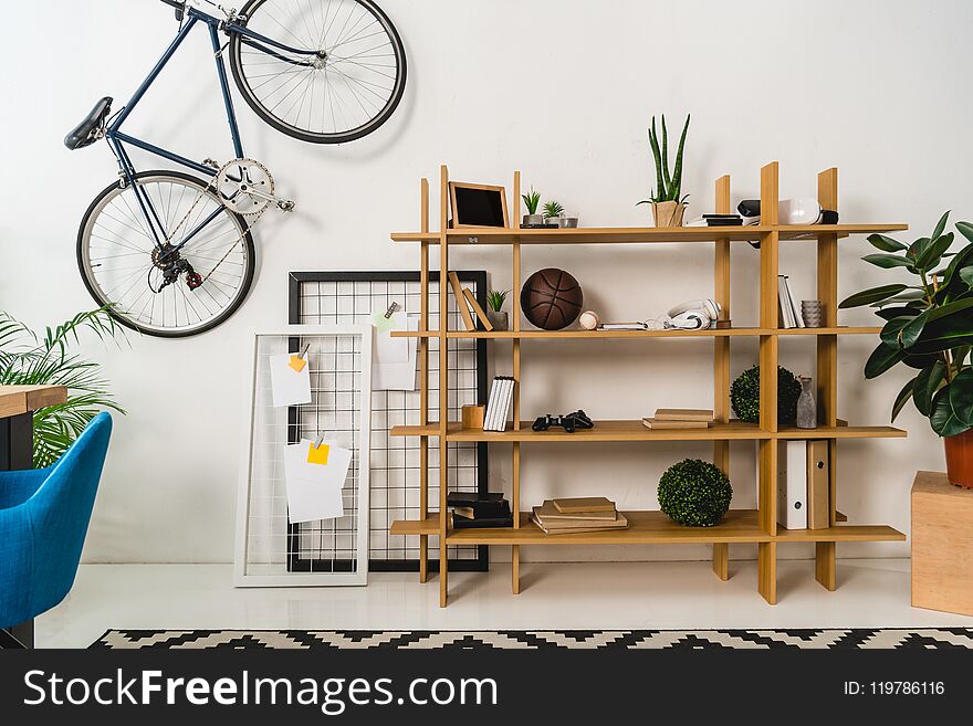 Bike On Wall And Shelves With Stuff