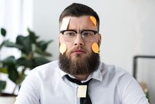 Portrait Of Serious Businessman In Formal Wear With Sticky Notes Royalty Free Stock Images