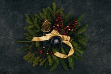 Top View Of Photo Camera And Festive Decorations On Fir Branches On Dark Tabletop Royalty Free Stock Image