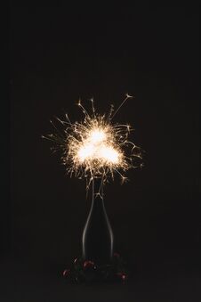 Close Up View Of Burning Sparklers In Bottle And Christmas Balls Isolated On Black Royalty Free Stock Image