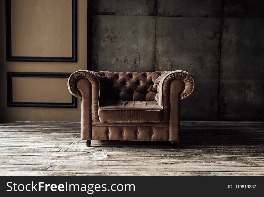 Luxurious Brown Armchair And Ashtray On Floor In Loft Interior