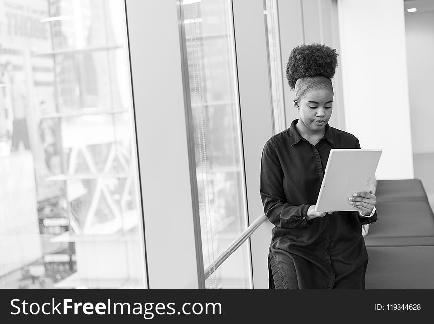 Grayscale Photo Of Woman Holding Tablet Computer