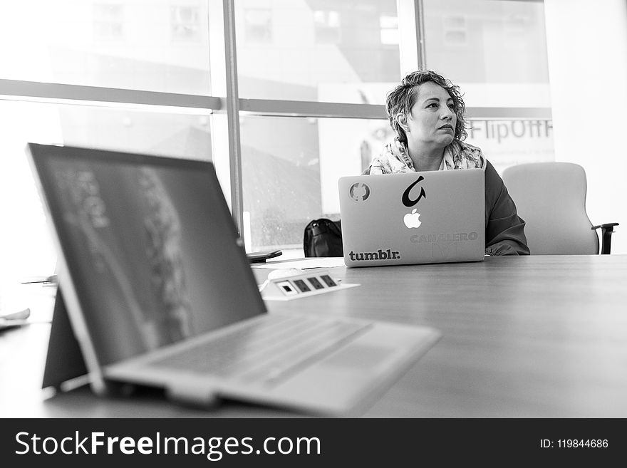 Grayscale Photography of Laptop Computer Near Woman Sitting on Chair