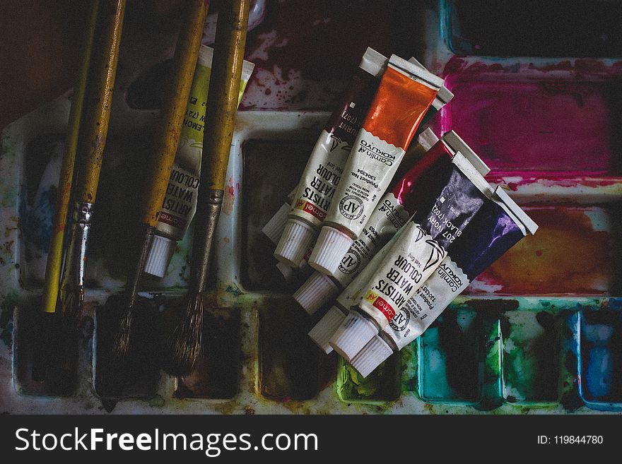 Photo of Acrylic Paint Soft-tubes Beside Paintbrushes