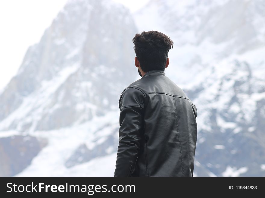 Man Wearing Black Jacket Looking at a Mountain