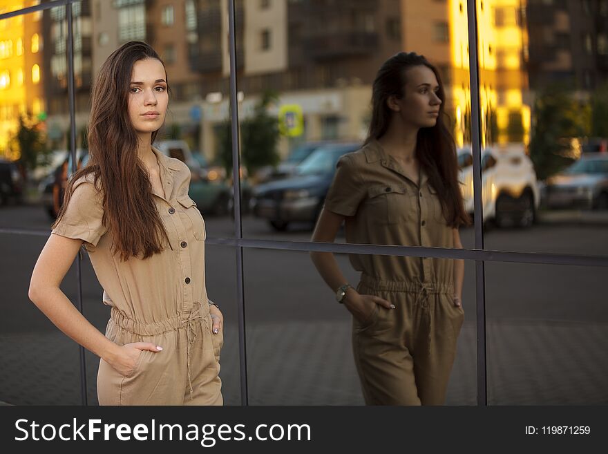 Fashion city portrait of stylish woman, natural nude makeup, long brunette hairs, walking alone at weekend, enjoy vacation, trendy summer outfit, evening soft sunlight
