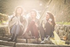 Three Young Girls Sitting On The Stairs At The Public Park. Royalty Free Stock Photography
