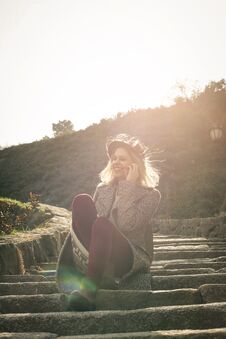 Young Beautiful Girl Sitting On The Stairs In The Park. Young Be Royalty Free Stock Photography