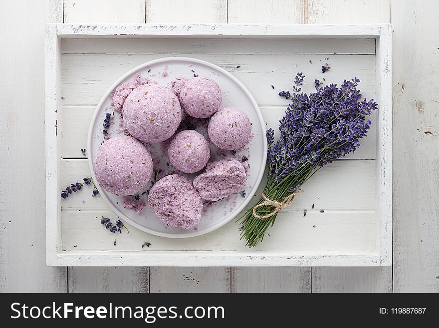 Handmade lavender bath bombs and flowers in white tray