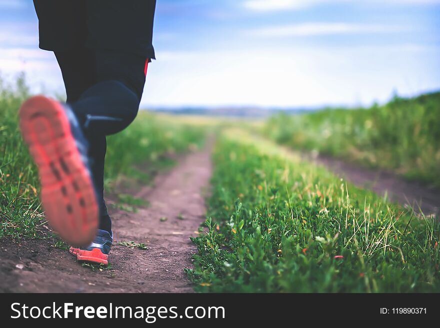 Close-up Jogging And Running Outdoors In Nature. Run People Outdoor. Athlete Wearing In Trainers And Leggings For Running