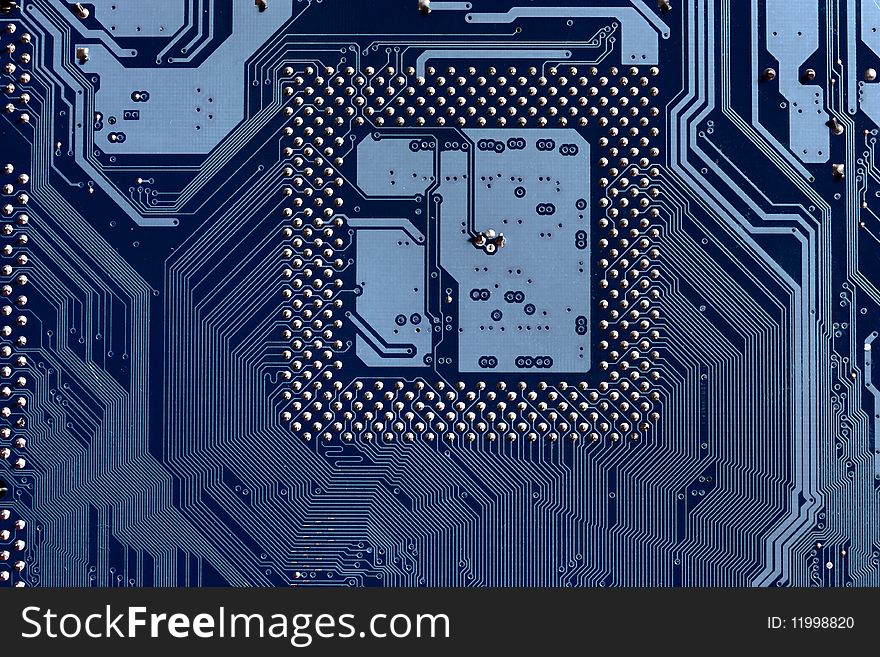 A macro view of the connections and chip slot, on an electronic circuit board. A macro view of the connections and chip slot, on an electronic circuit board.