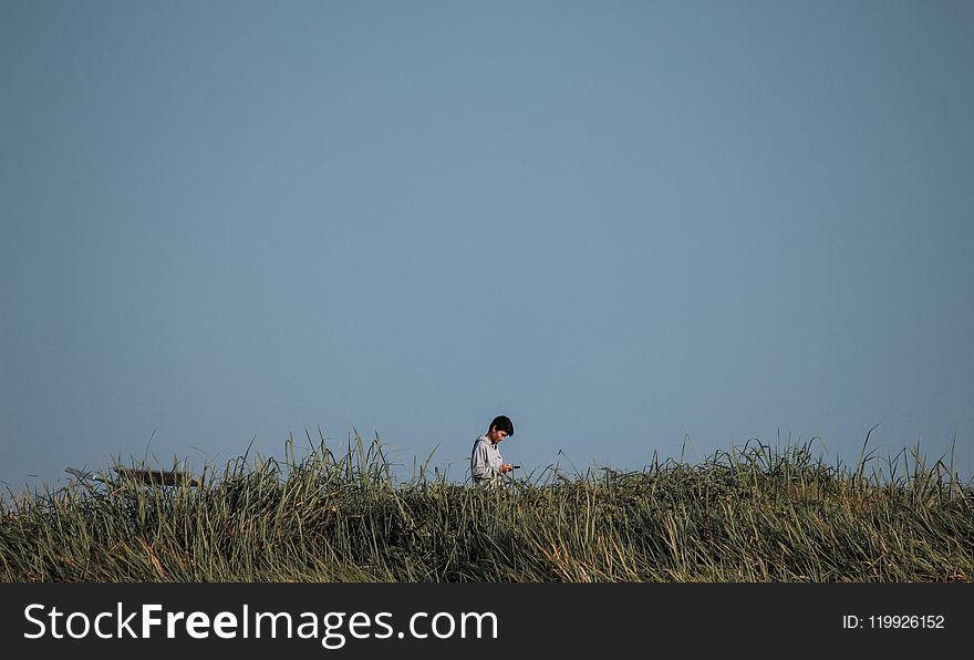 Man Standing On Green Grass