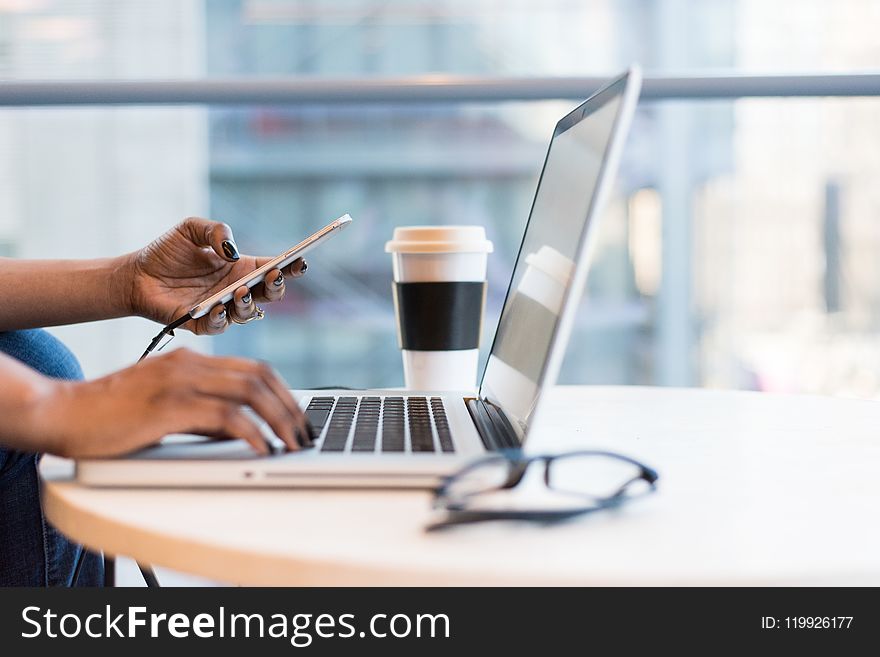 Person Using Macbook Air On Table