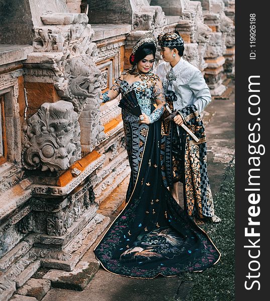 Photography of Woman in Black and Blue Lace Dress Beside Man
