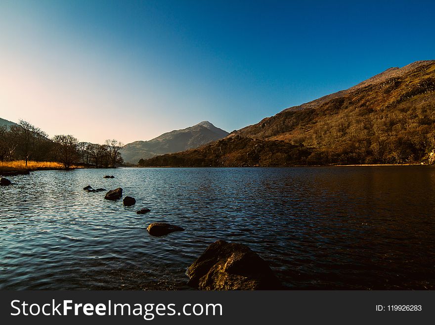 Landscape Photography of Body of Water Near Mountain