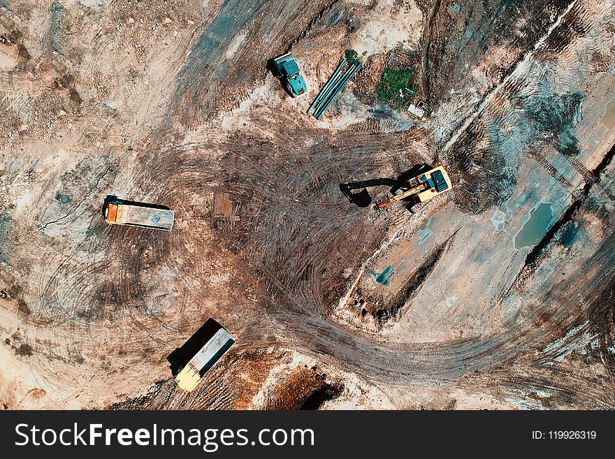 Aerial View Photography Of Utility Vehicles On Brown Soil