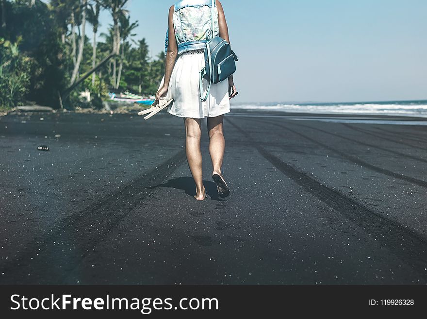 Woman Walking By The Sea