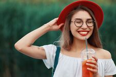 A Young Stylish Woman Having A Refreshing Drink While Walking Royalty Free Stock Images