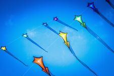 Brightly Colored Flying Kites Against A Summer Blue Sky Royalty Free Stock Image